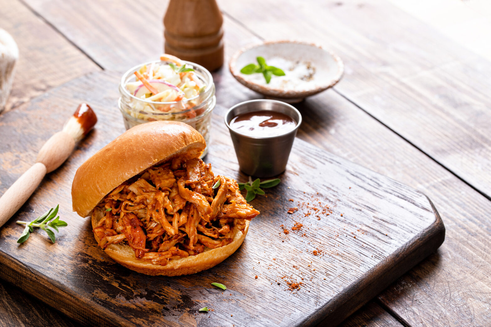 Pulled bbq chicken sandwich on a brioche bun served with cole slaw and bbq sauce. For an easy crockpot recipe check out today's story.