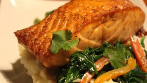 Baked salmon on a plate. This quick and easy recipe is a great way to liven up your night with a healthy meal.