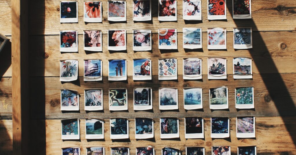 A collage of Polaroid pictures plastered on a wooden wall