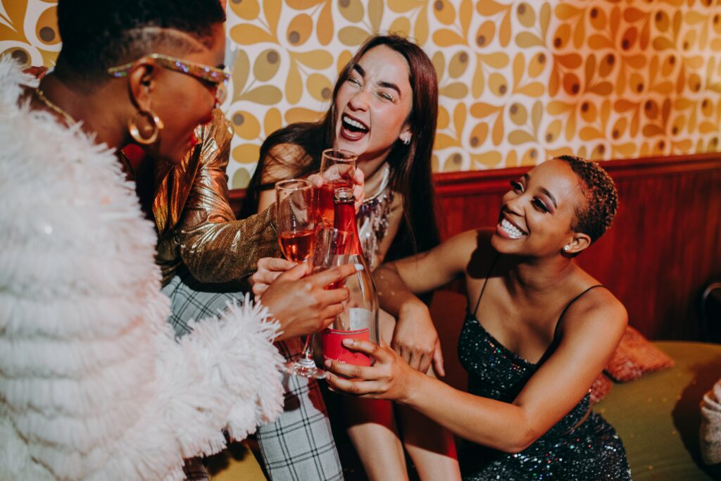A group of women laughing together while out a social venue