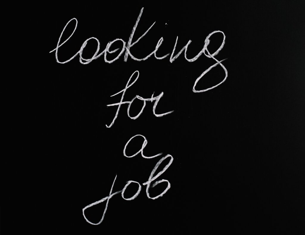 The words "looking for a job" written in cursive in white chalk