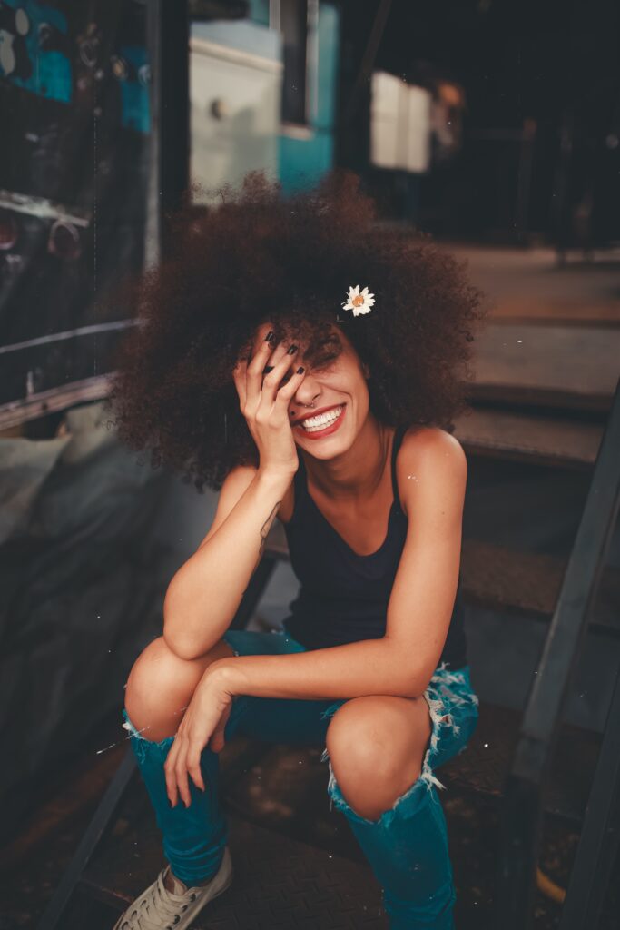 Woman with an afro smiling into the camera