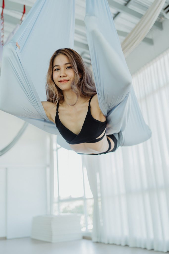 Woman wrapped in silks during aerial yoga hobby