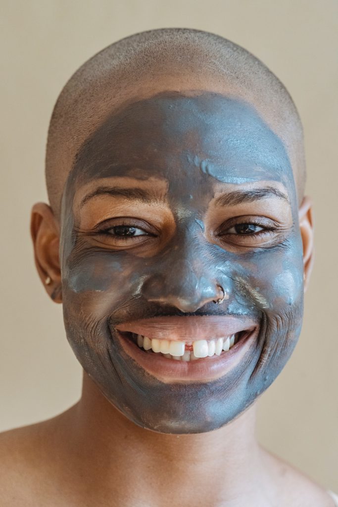 Black woman with a shaved head wearing a face mask