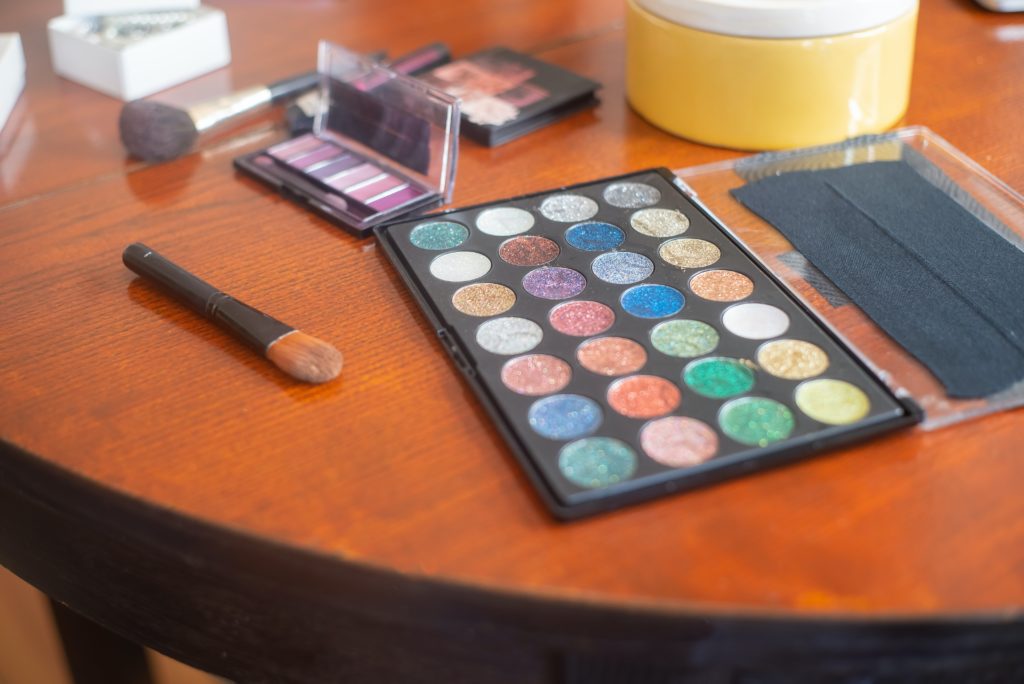 Multi-colored eyeshadow palettes sitting on a table