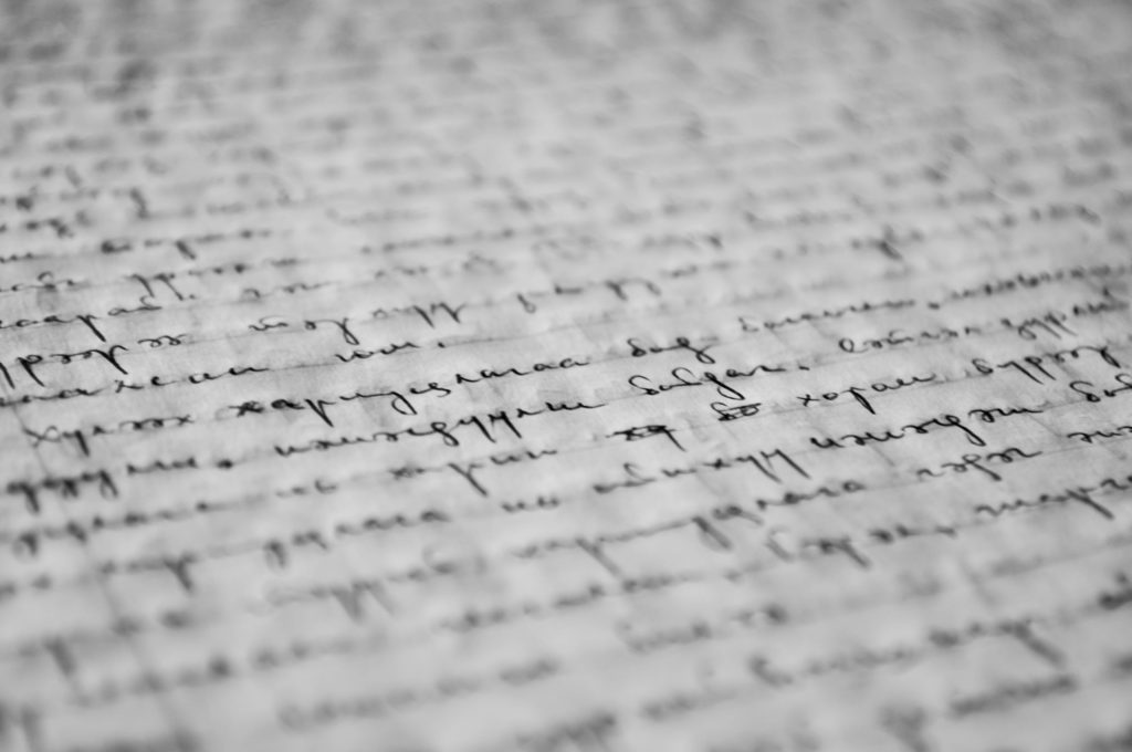 Cursive words handwritten on a piece of lined paper