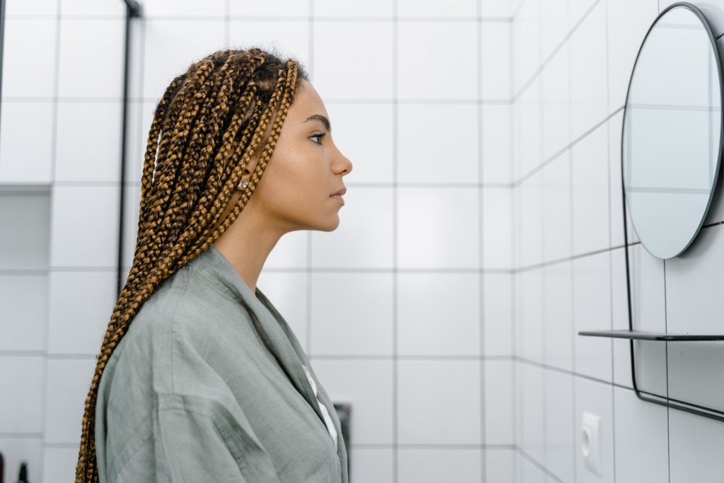 Black woman looking in the mirror