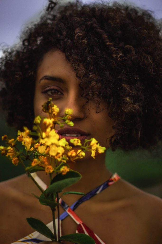 Black woman holding a flower