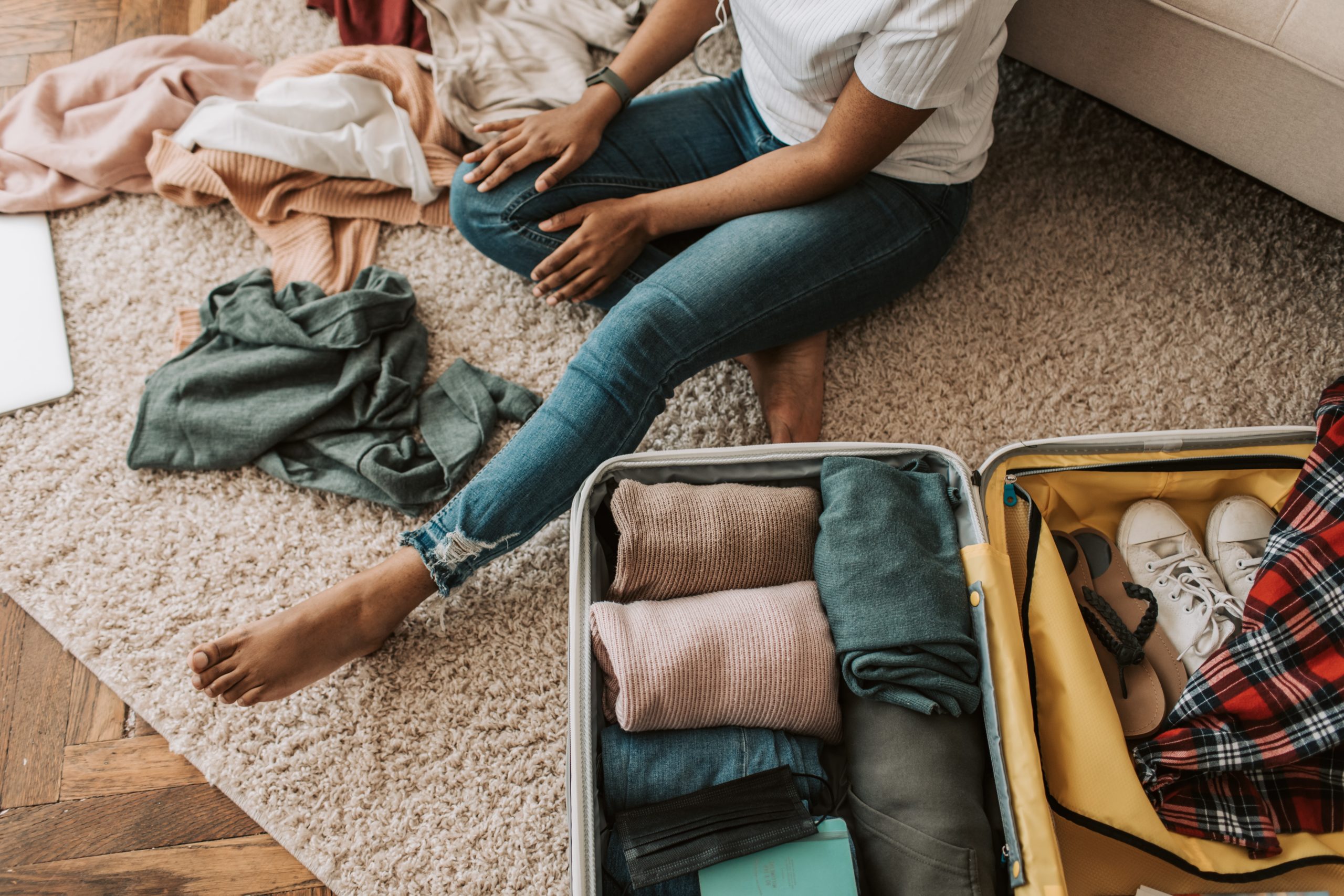 Black girl packing her suitcase for an overnight stay