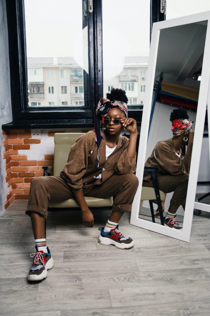 Black girl sneakerhead posing in front of a mirror
