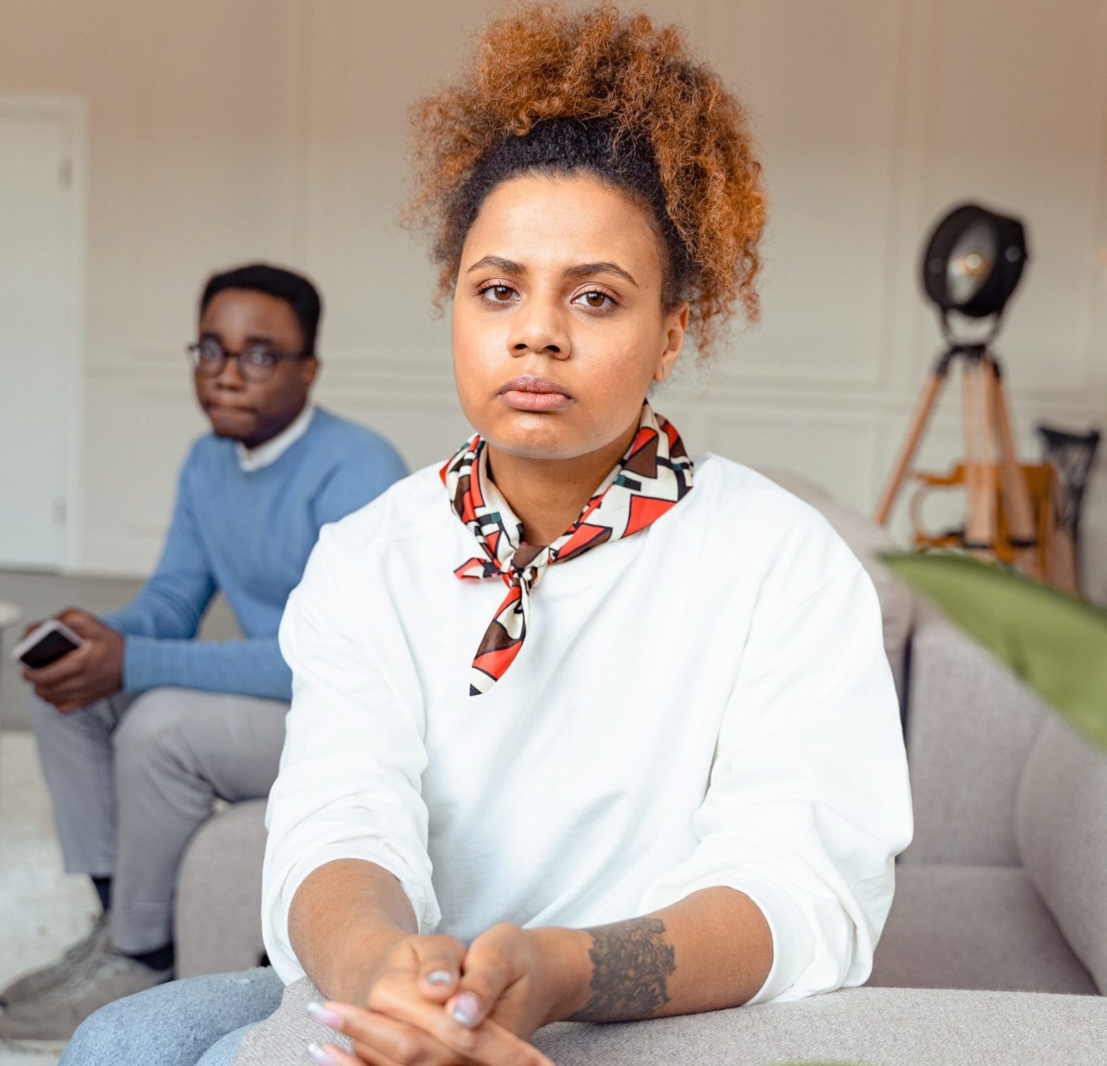 Picture of black couple looking away from each other and towards the camera with a concerned look on faces. If you are concerned that you are dealing with a beta male in your life, take a look at today's article for some advice.
