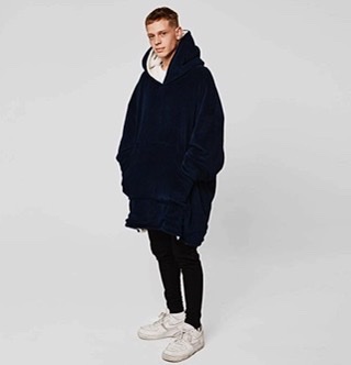A male model wearing the Hooded Blanket from Sienna