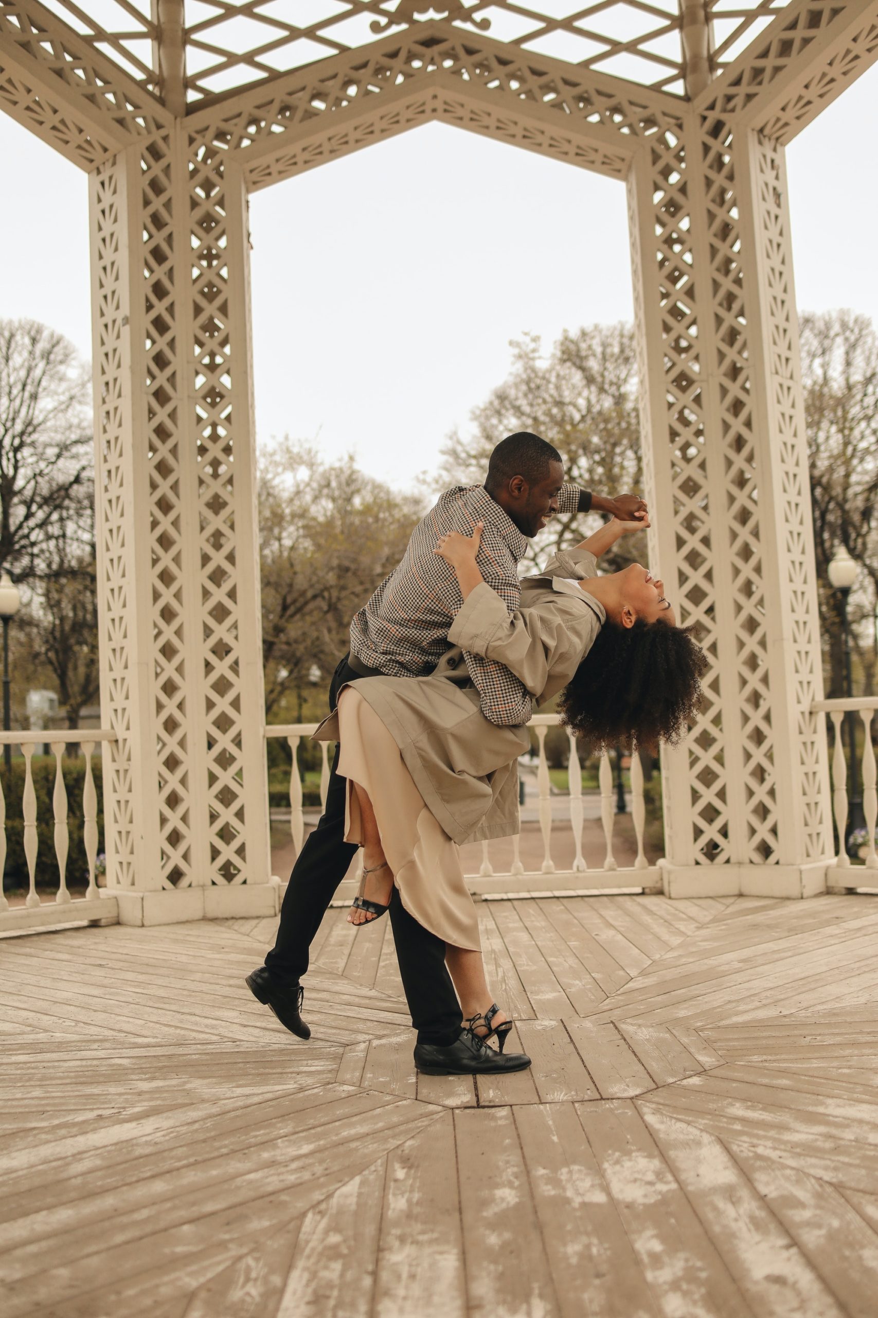A Black couple dancing outside