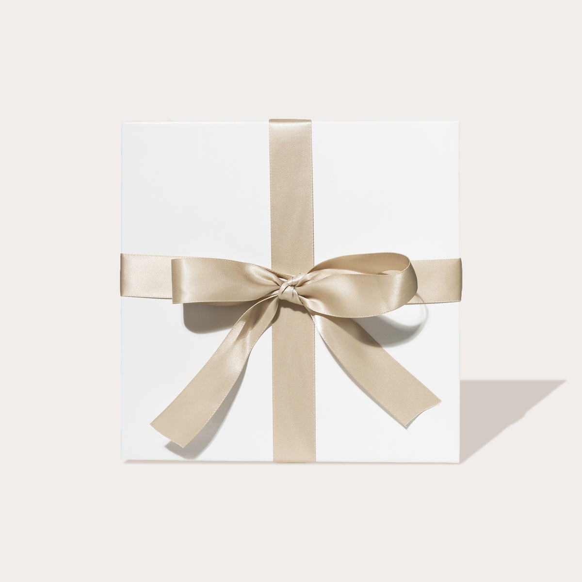 A closeup of the "Travel Essentials" gift set wrapped with a bow.