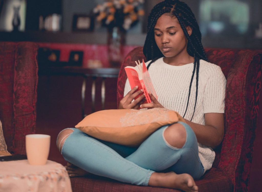 Black woman with braids reading a book