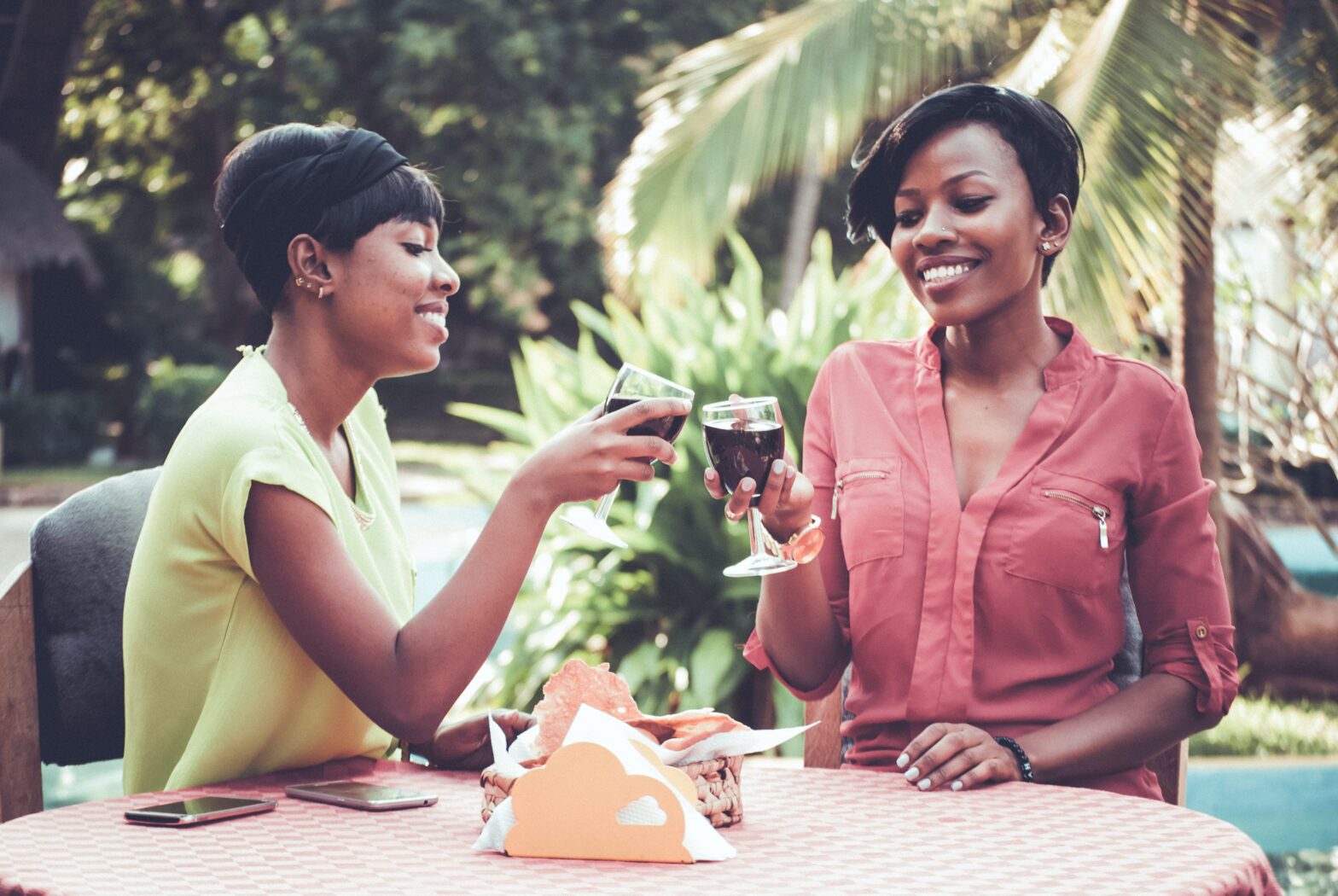 Two women drinking wine from Black-owned wine brands