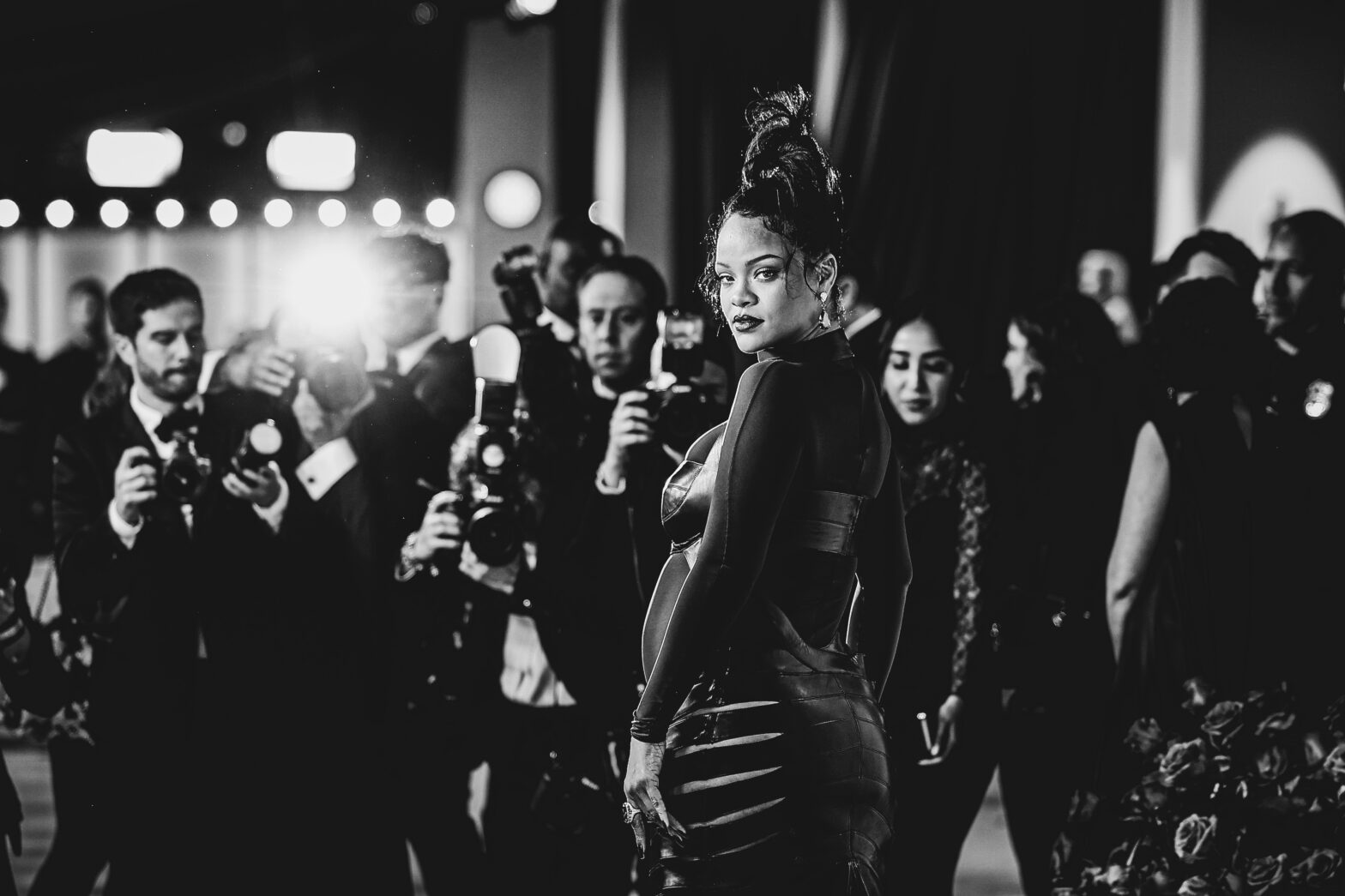 rihanna with photographers behind her