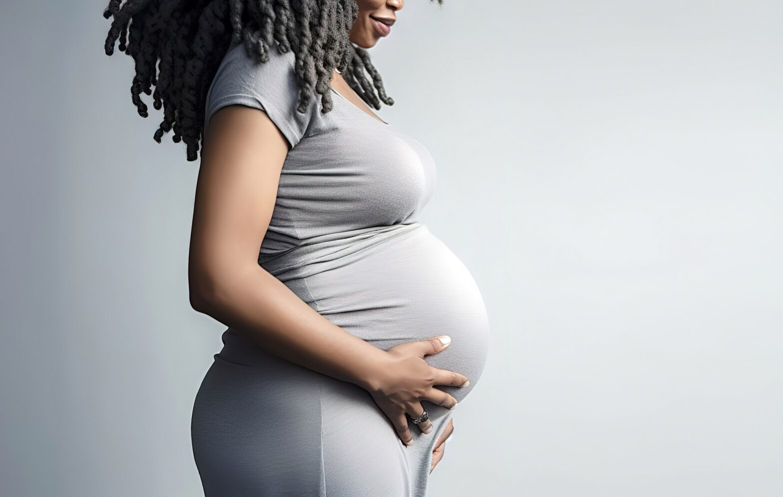 A black woman holding her pregnant womb. Can being pregnant with twins cause a false negative pregnancy test?