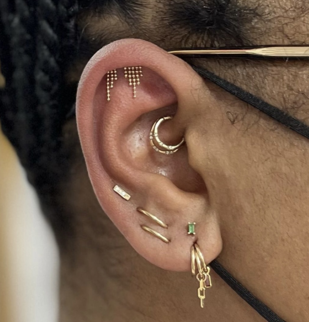 Nothing switches up a look quite like some bold daith jewelery. Here's what you need to know about the piercing, plus some look inspo. pictured: a pierced ear with daith jewelry.