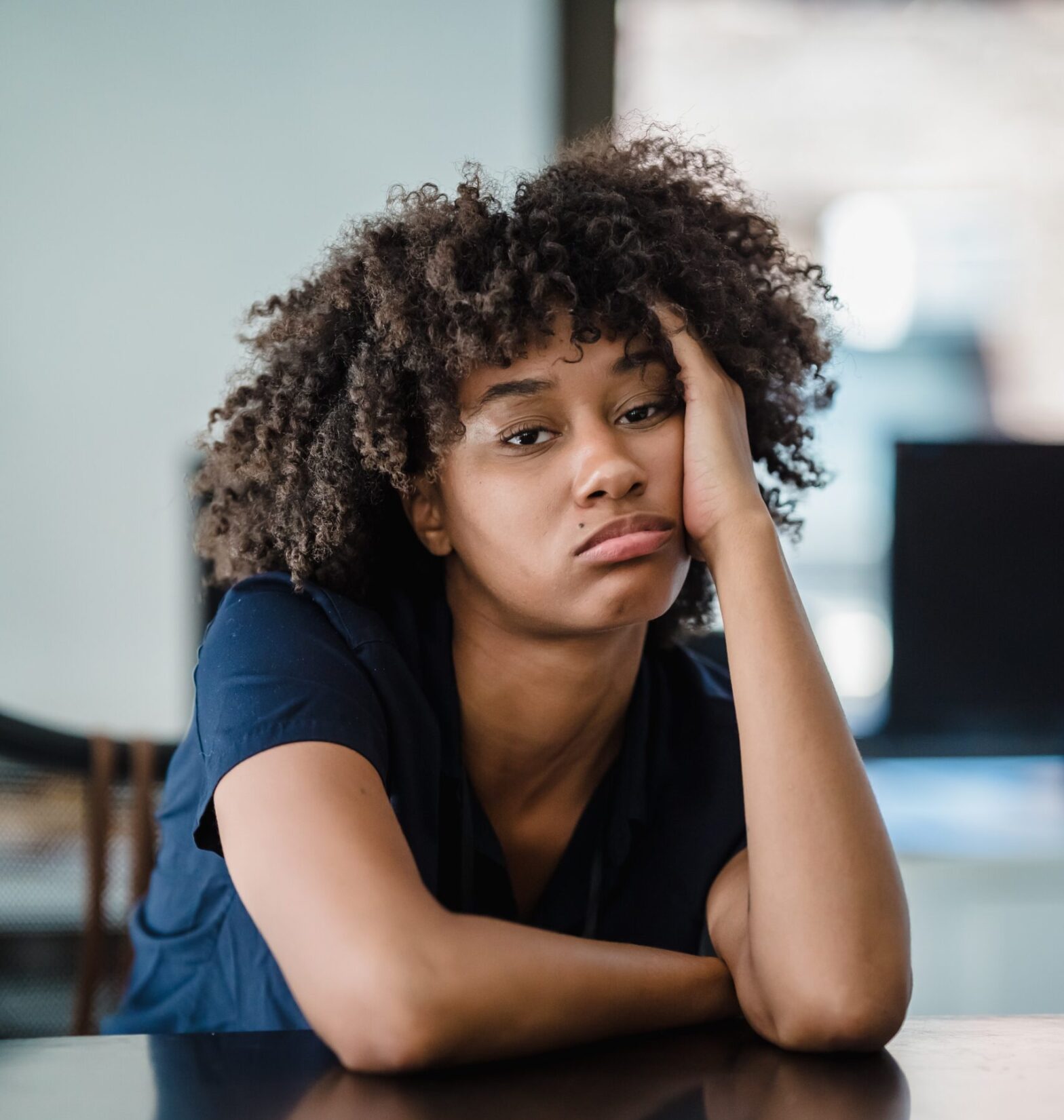 A young Black woman with a bored look on her face. If you are bored and need to know what to do, here are a few ideas.