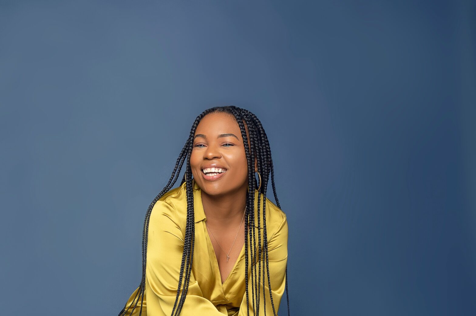 Get inspired by different types of braids that will transform your look, from fulani braids, to knotless, to box braids. Pictured: Black girl smiling with box braids.