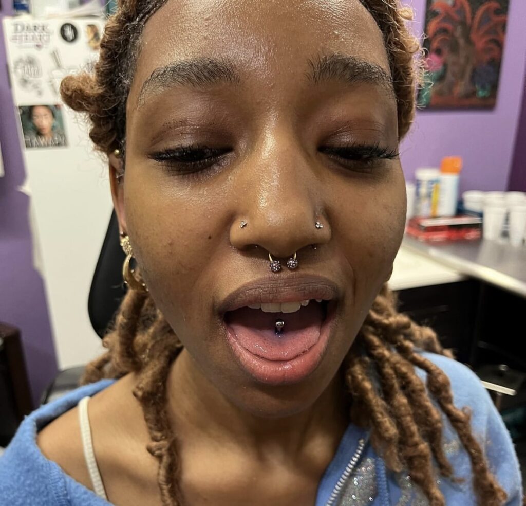 Where tongue piercings rank in most painful piercings. pictured: black girl with tongue and nose rings