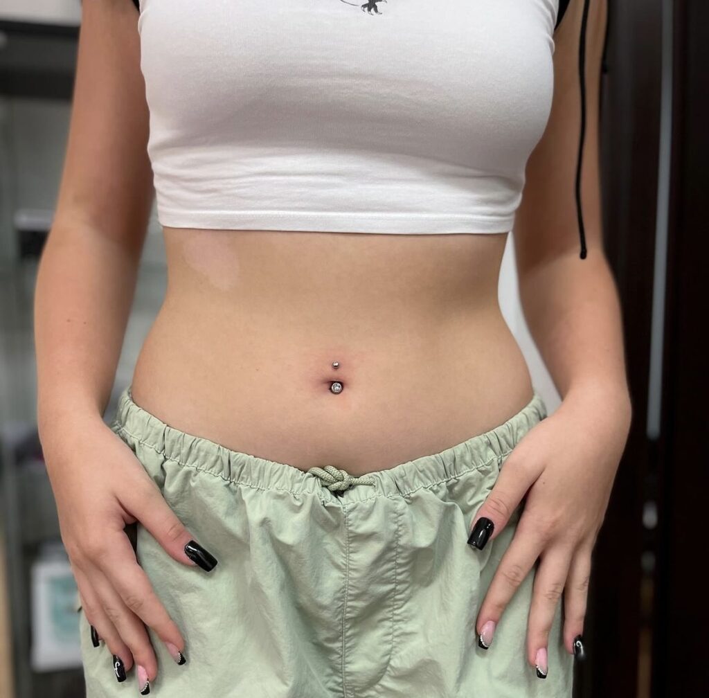 Where belly piercings rank in most painful piercings. pictured: torso with belly button piercing 
