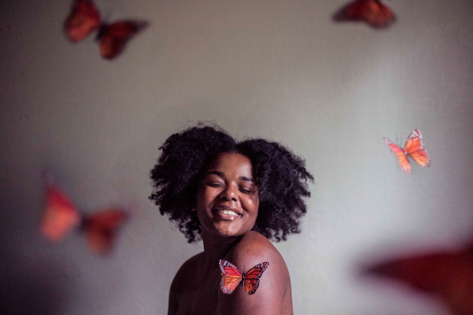 Pap smear on your period. pictured: a young Black woman surrounded by butterflies