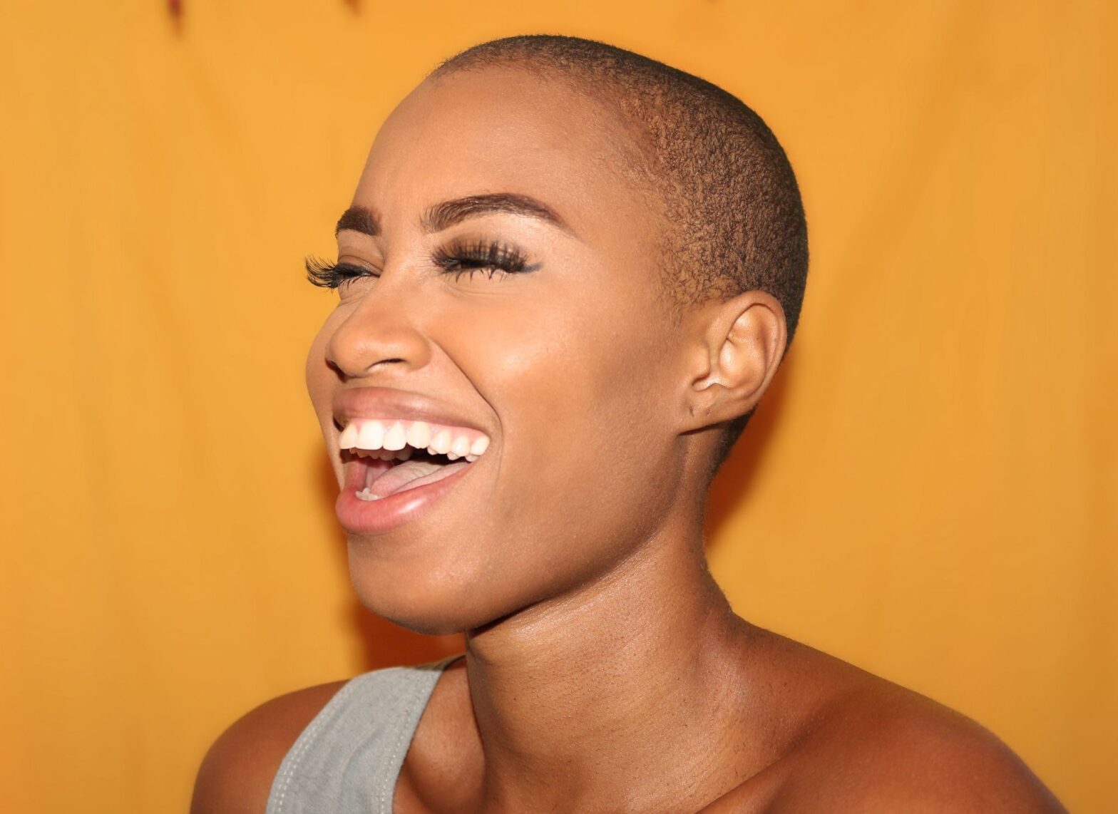 Black-woman-laughing-yellow-background