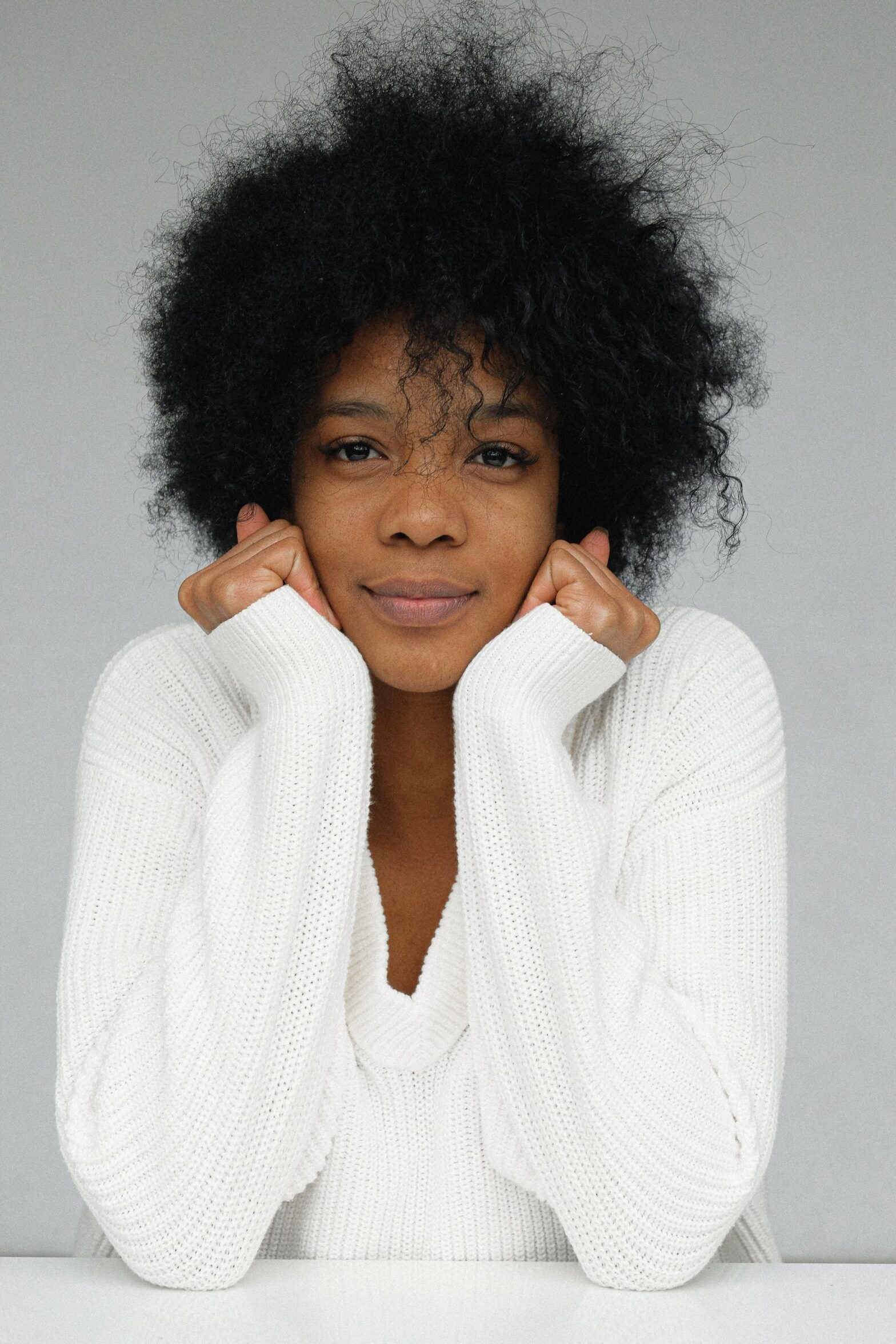 A woman in a white sweater