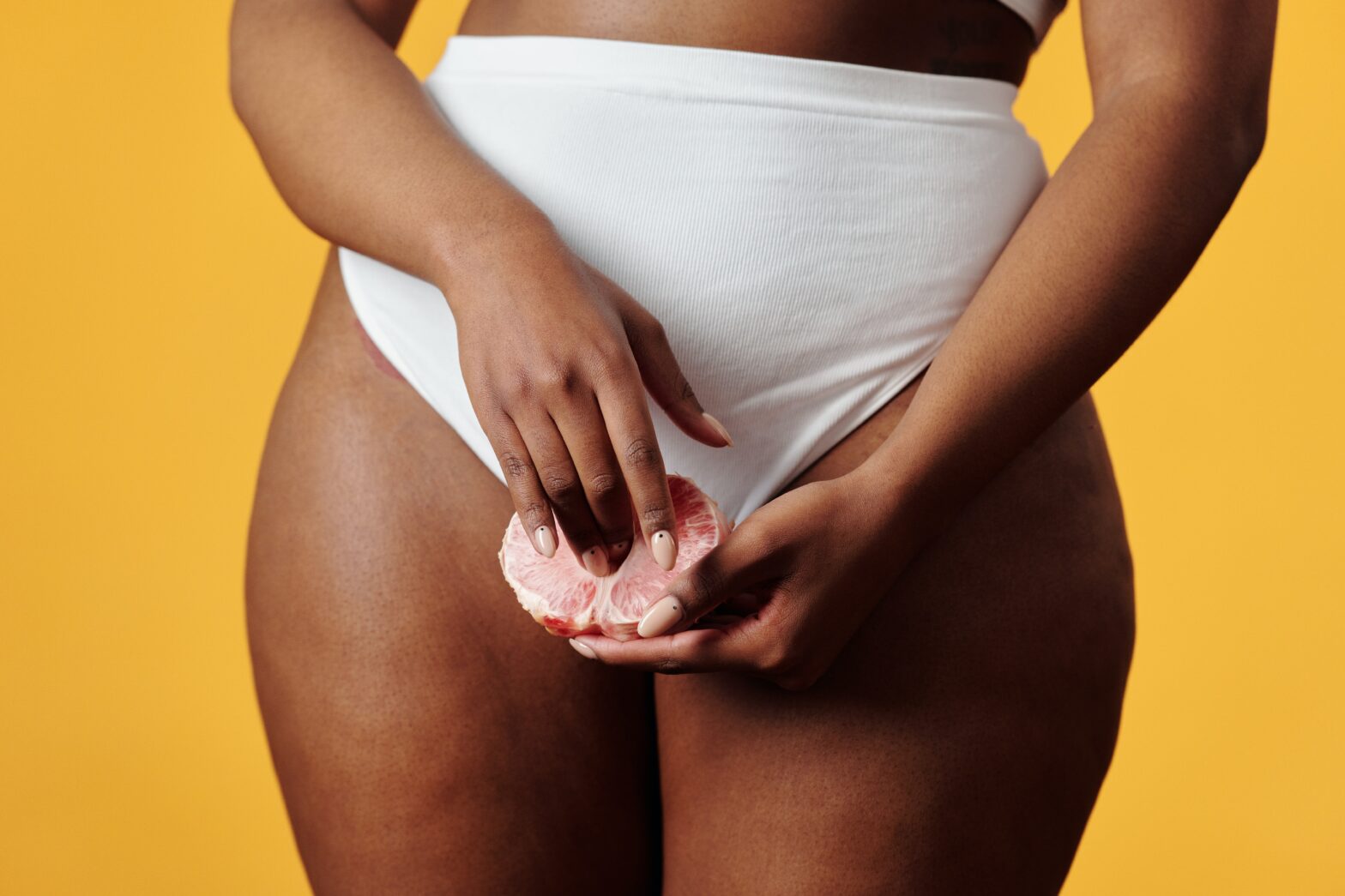 close-up-Black-woman-in-white-underwear-holding-pomelo