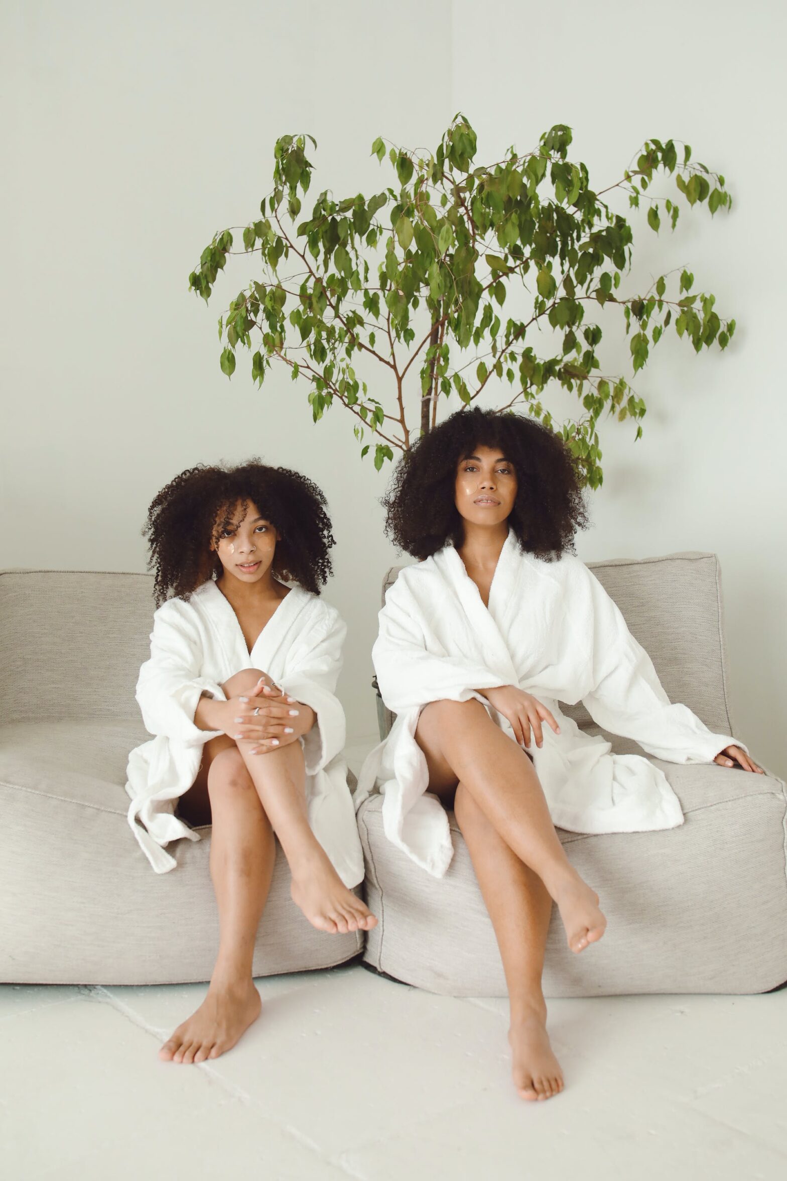 Two women sitting in robes at a spa