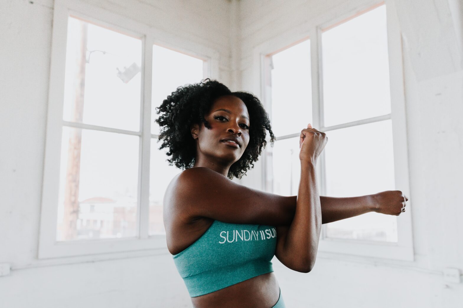 If you’ve found yourself asking “Why am I not losing weight on Ozempic,” you’re certainly not alone, so let’s deep dive into the science behind the injection. pictured: black girl stretching
