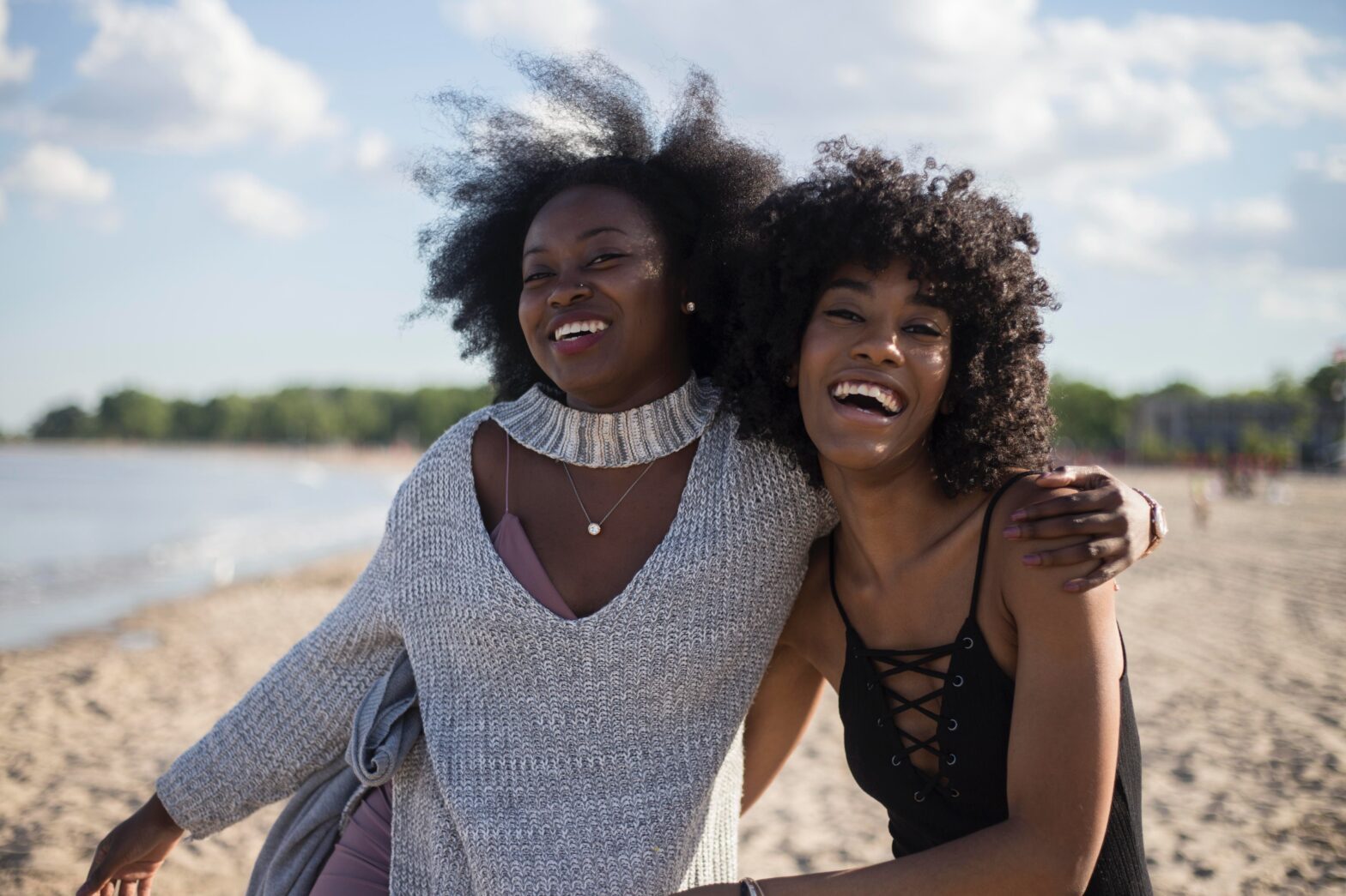 Some of the most impactful relationships in our lives are the ones we share with those very specific friends, family members, or co-workers who feel sent from above. These are known as our platonic soulmates, and here’s how to know if you have one in your life. pictured: two black girls hugging.