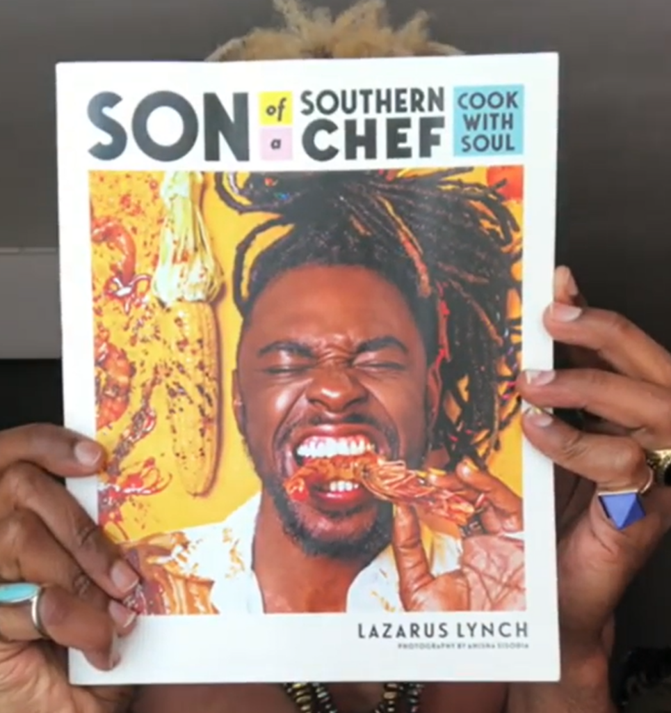 A man holding up a cookbook