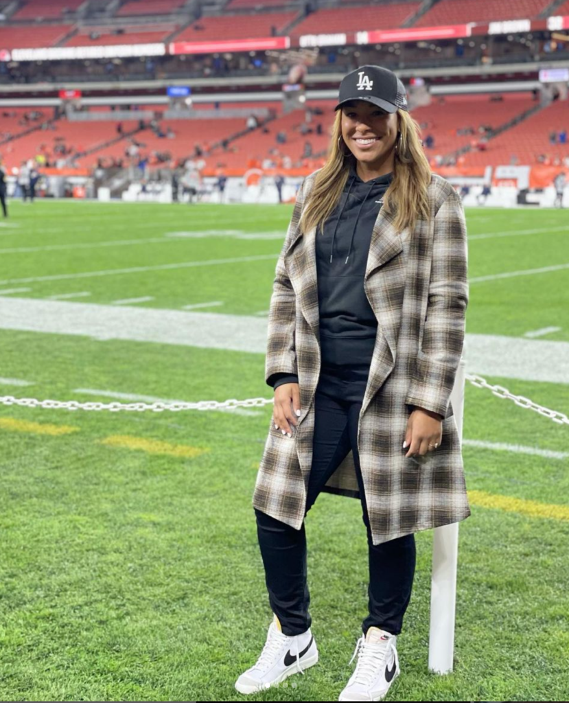 A woman standing on a football field 