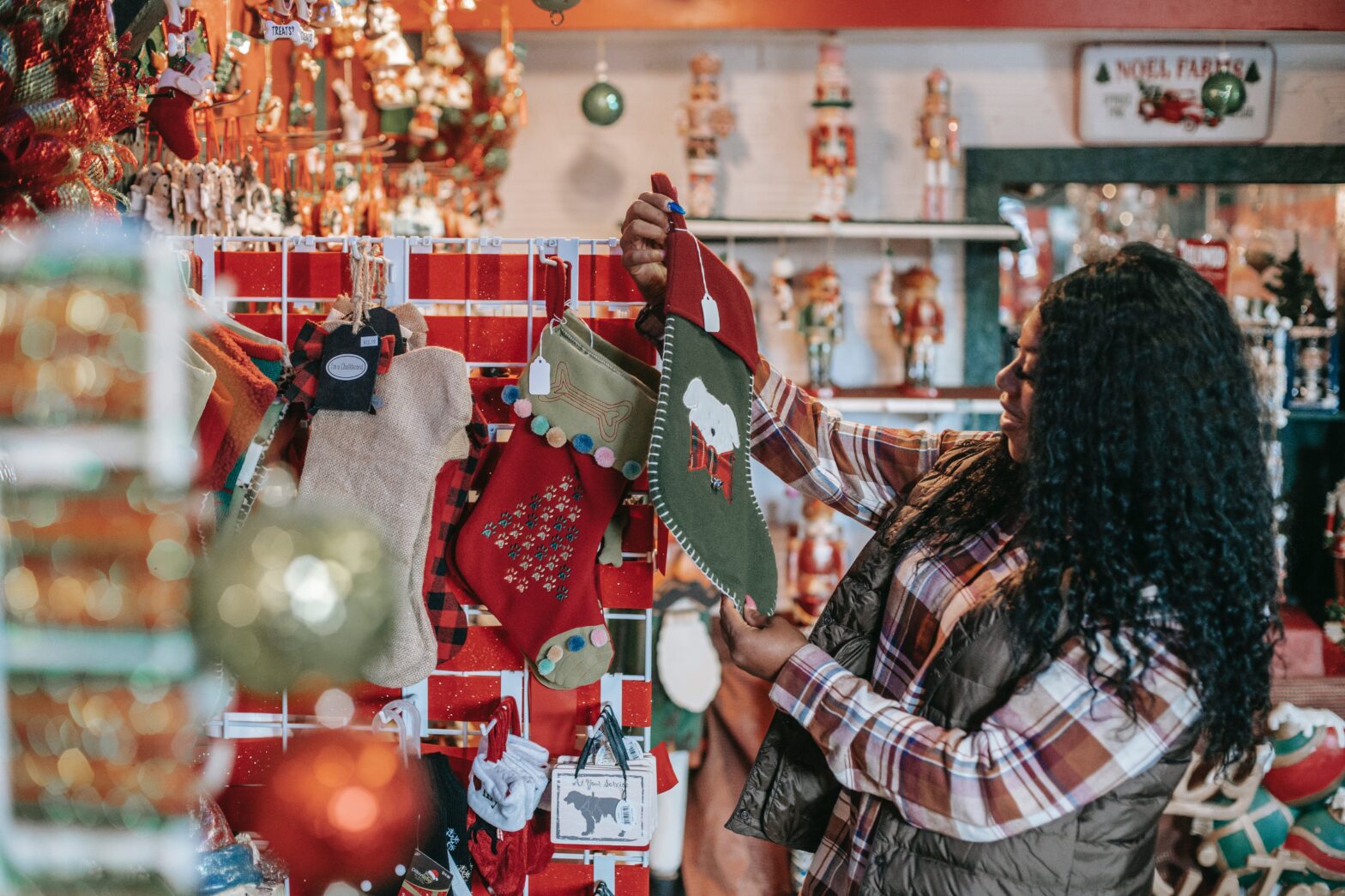 smiling-Black-woman-choosing-christmas-decorations-in-store