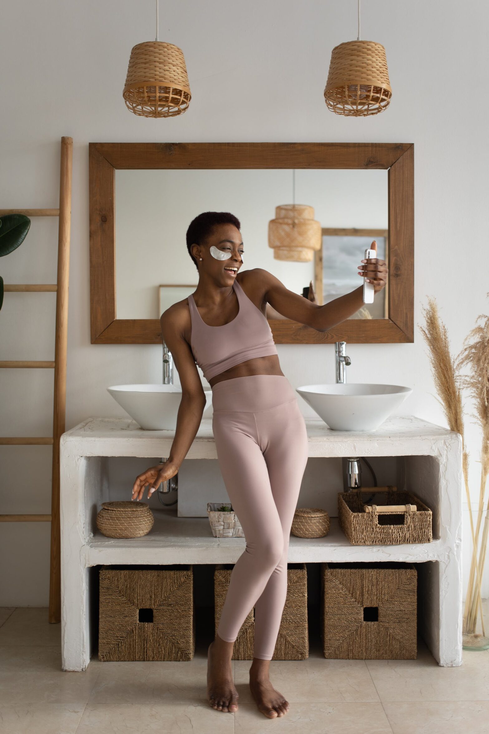A woman in loungewear standing in front of the mirror