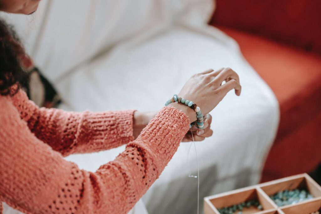 A woman making a bracelet