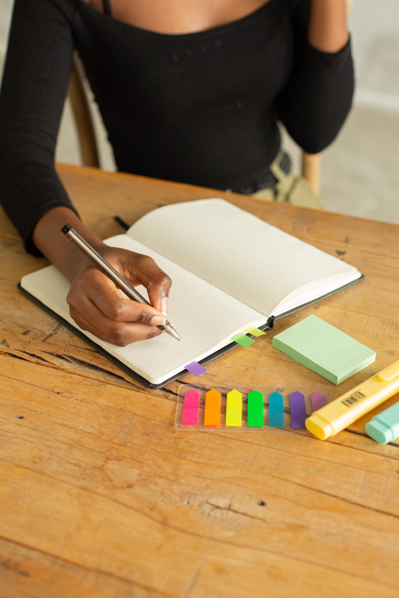 A woman with a journal and sticky notes