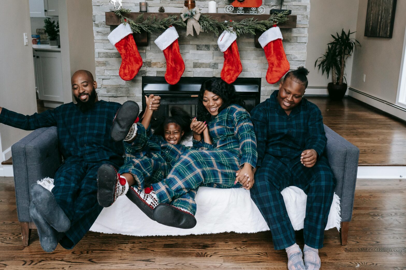glad-Black-family-having-fun-on-couch