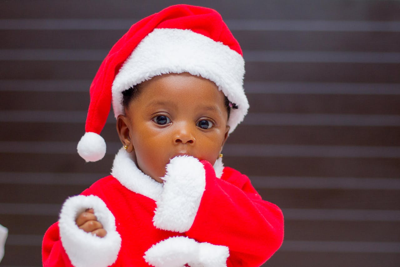 Black baby boy dressed in a Santa outfit