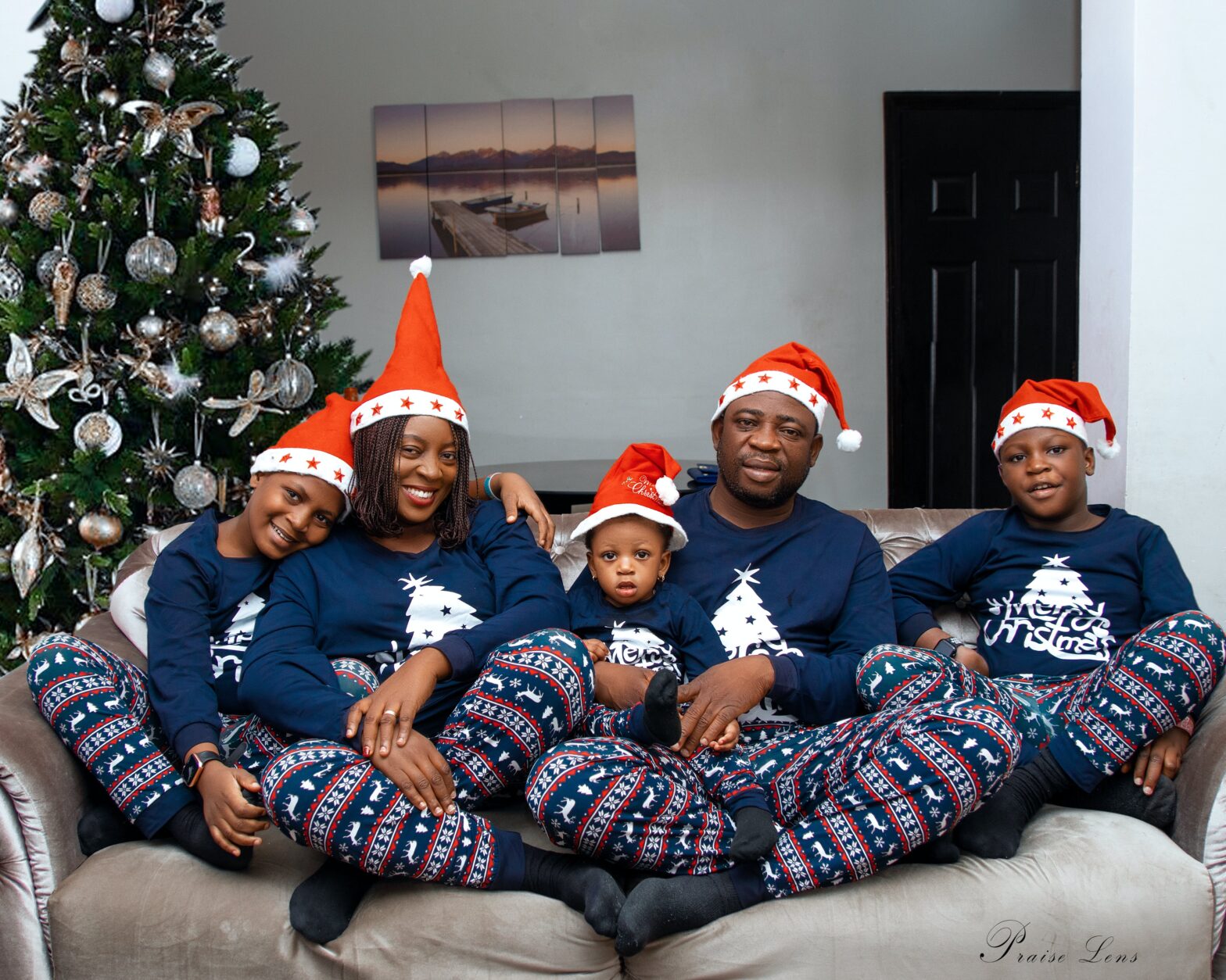 a-happy-Black-family-wearing-santa-hat-and-blue-pajamas-photo