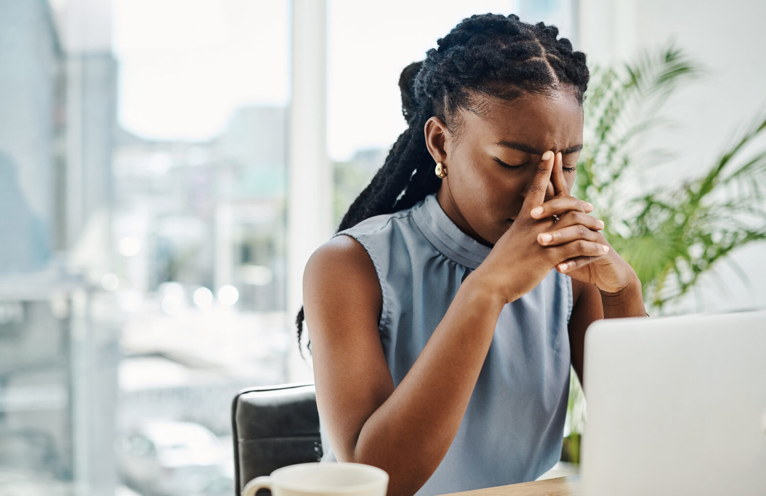 a black women sitting at her desk stressed over perfectionism