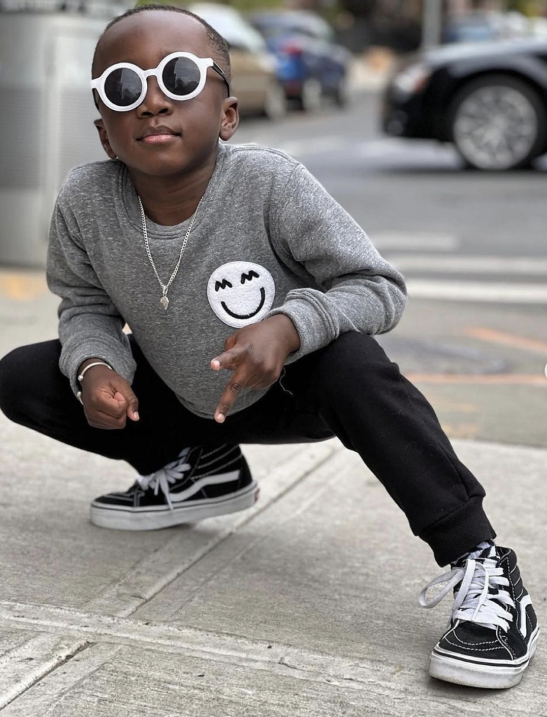 a kid with sunglasses posing