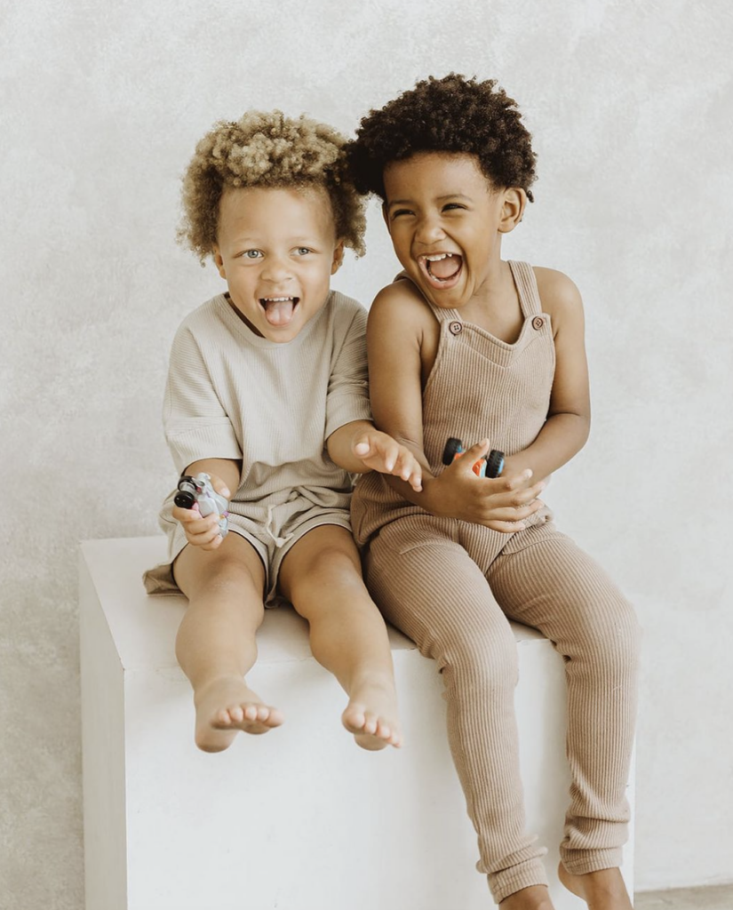 Two kids sitting on a cube