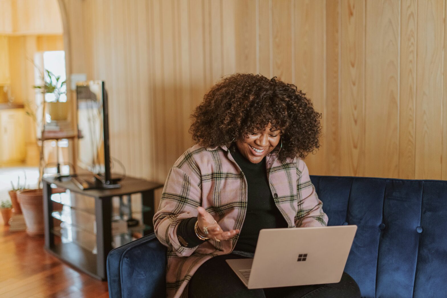 Long Distance Valentine's Ideas pictured: woman smiling at laptop