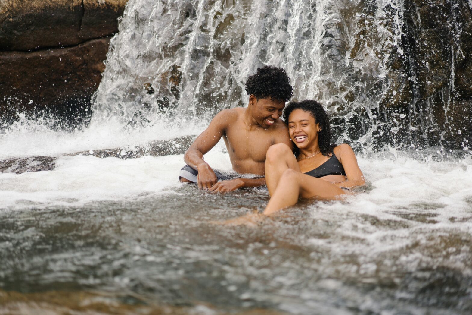 Leo and Pisces Compatibility pictured: couple smiling in the water