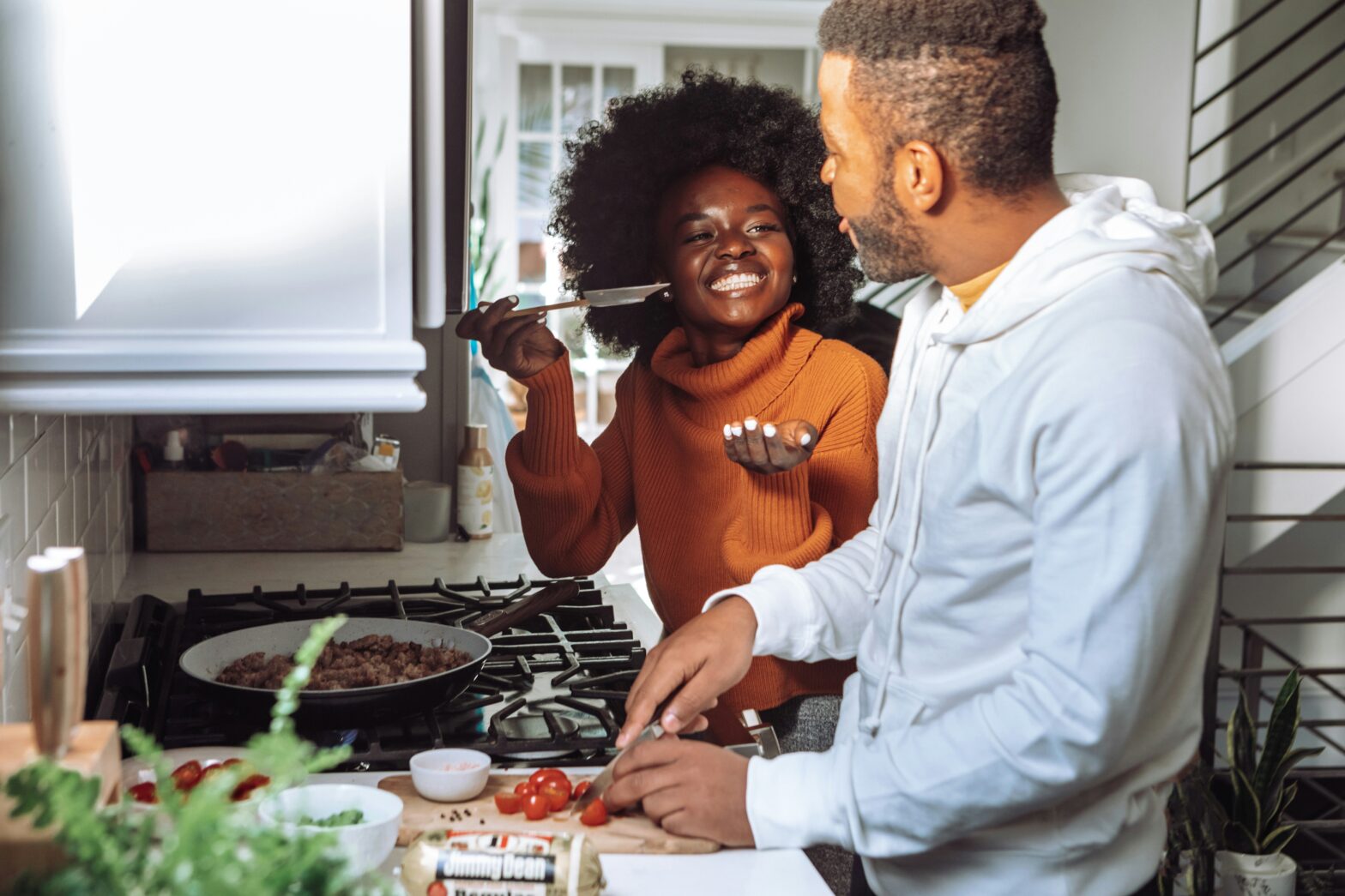 Virgo and Pisces Compatibility pictured: couple cooking in the kitchen