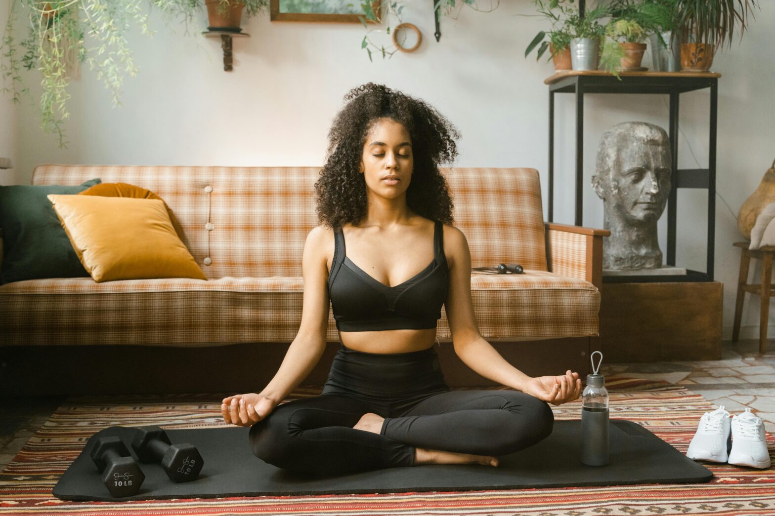 Black-woman-in-activewear-meditating-indoors-spring-workout-gear